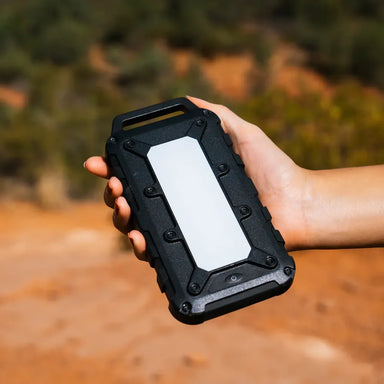Lion Energy Lion Cub 10,000mAh rugged power bank held outdoors