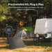 Renogy 200W portable solar panel kit deployed at a campsite next to a tent and an RV, showcasing its plug-and-play pre-installed PWM controller.