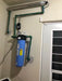 Crystal Quest Big Blue SMART single whole house water filter installed with UV water sterilizer and green piping.