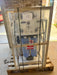 A Crystal Quest whole house reverse osmosis system securely packaged in a wooden shipping crate and palletized for safe delivery.