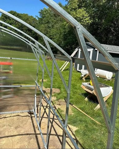 Interior close-up of a GreenhouseToGrow Magnolia 10x39 Greenhouse Kit showing the heavy-duty galvanized steel arch and frame reinforcement.