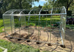 Full metal frame skeleton of the GreenhouseToGrow Magnolia 10x39 Greenhouse Kit installed on a prepared dirt foundation with anchor points.
