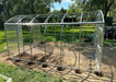 Partially assembled frame and polycarbonate panels of a GreenhouseToGrow Magnolia 10x32.5 Greenhouse Kit showing ground anchor holes.