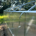 Exterior side panel view of the Magnolia 10x6.5 Greenhouse highlighting the metal tightening straps used to secure polycarbonate panels.