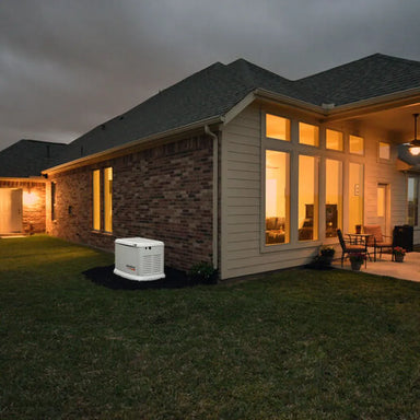 Generac 10kW aluminum standby generator powering modern home exterior at dusk