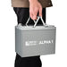 Side view of a person easily carrying the portable Rich Solar ALPHA 1 12V lithium battery using its built-in handles.