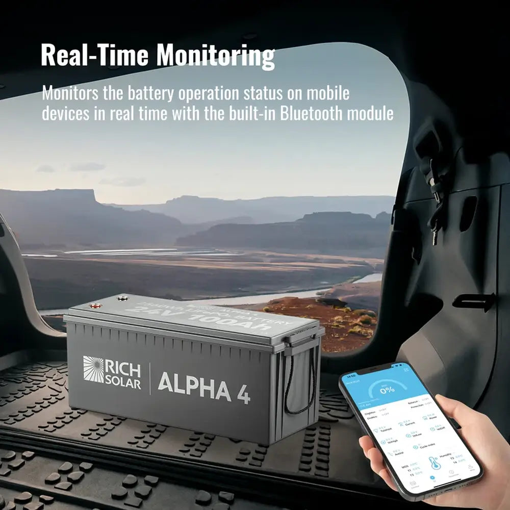 Smartphone app displaying real-time Bluetooth monitoring of the Rich Solar ALPHA 4 24V 100Ah Lithium Battery inside a vehicle trunk.