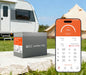 Smartphone displaying a smart Bluetooth BMS app interface showing 89% state of charge next to a Rich Solar ALPHA 1 PRO lithium battery at an RV campsite.