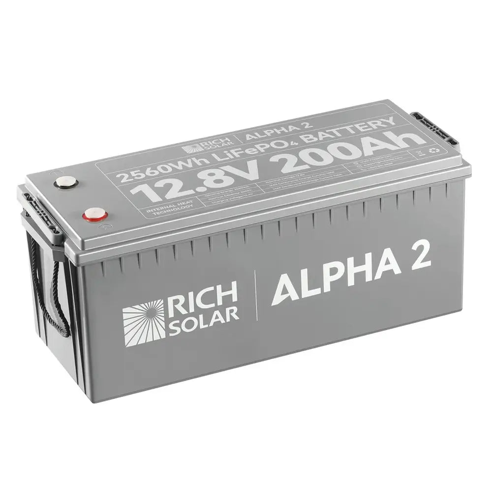 Top-down angle of the Rich Solar Alpha 2 12.8V 200Ah LiFePO4 battery showing printed technical specifications, terminal placements, and product ratings on the lid.