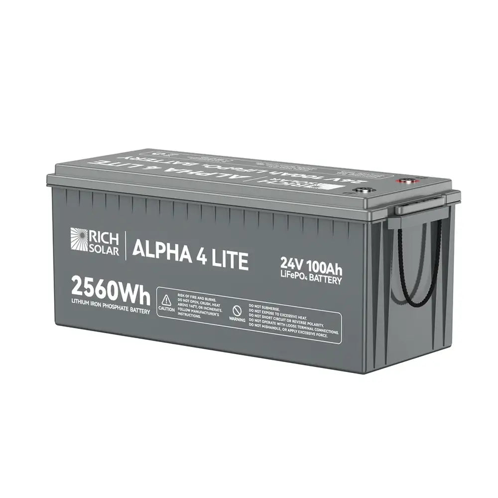 Front-left view of the Rich Solar ALPHA 4 LITE 24V 100Ah Lithium Iron Phosphate Battery, displaying the 2560Wh capacity spec and printed safety warnings on the casing.