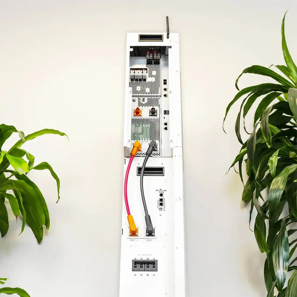 Side connection profile of a wall-installed Rich Solar RS-A10 ESS showing heavy-duty red and black DC battery cables linking the stacked components.