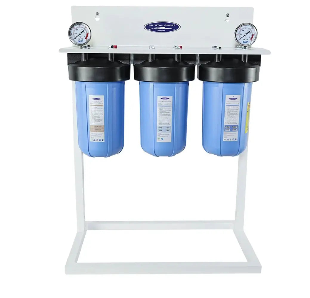 3-stage Crystal Quest alkalizing water filtration system on a white floor stand with blue filter housings.