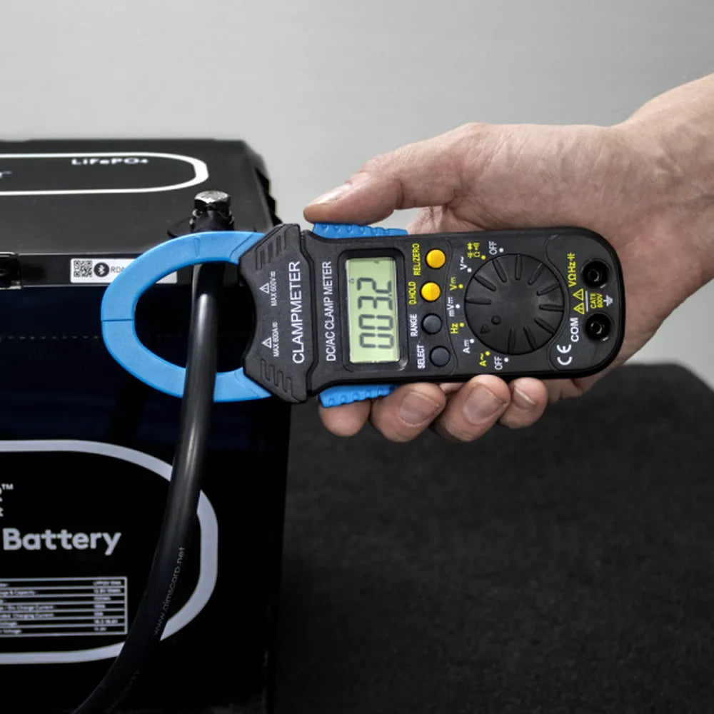 AIMS Power clamp meter measuring battery cable current with handheld digital electrical tester.