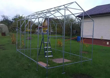 Galvanized steel frame assembly process of a GreenhouseToGrow Daisy 8.3'x32.5' Greenhouse Kit in a backyard.