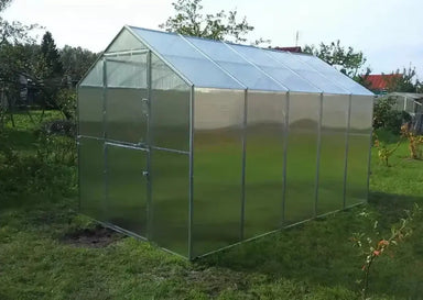 Fully assembled GreenhouseToGrow Daisy 8.3'x13' polycarbonate greenhouse kit featuring a sleek gable roof and clear panels.