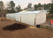 Long exterior profile of the 39-foot Magnolia Greenhouse Kit extension showcasing the opaque polycarbonate glazing and extended growing space.