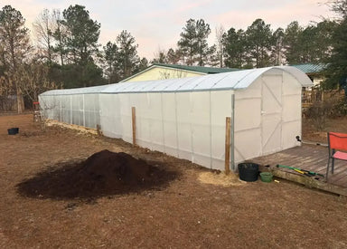 Long exterior profile of the 39-foot Magnolia Greenhouse Kit extension showcasing the opaque polycarbonate glazing and extended growing space.
