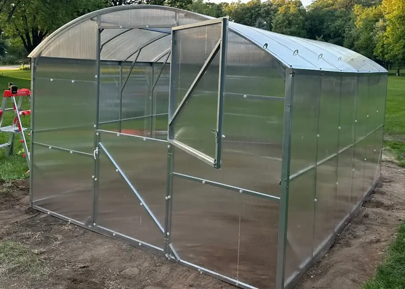 Exterior front view of the GreenhouseToGrow Magnolia 10x39 Greenhouse Kit featuring a heavy-duty galvanized steel frame and a functional split Dutch door.