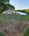 Exterior perspective of the GreenhouseToGrow Magnolia 10x13 Greenhouse Kit highlighting the dual-part split door and rust-resistant galvanized steel frame in a backyard setting.