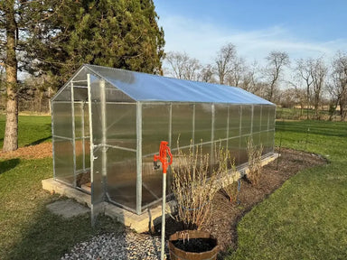 GreenhouseToGrow Daisy 8.3'x32.5' Greenhouse Kit installed on a raised stone brick foundation with the top door open.