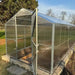GreenhouseToGrow Daisy 8.3'x6.5' Greenhouse Kit with an open door revealing an interior garden bed layout.