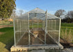 Front entrance view of the Daisy Greenhouse Kit featuring open Dutch-style double doors and interior bracing.