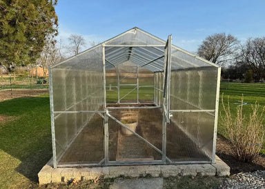Front entrance view of the Daisy Greenhouse Kit featuring open Dutch-style double doors and interior bracing.