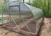 Wide-angle front view of the finished GreenhouseToGrow Camellia 10x32.5 Greenhouse Kit featuring a reinforced double-door entry system.