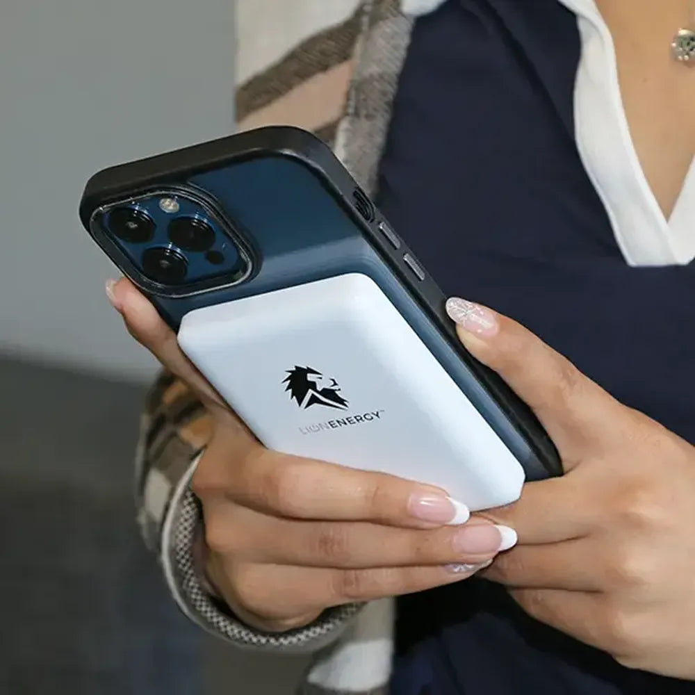 Person holding iPhone with Lion Energy Lion Claw magnetic power bank