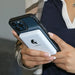 Person holding iPhone with Lion Energy Lion Claw magnetic power bank