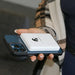 Hand holding iPhone with Lion Energy Lion Claw magnetic power bank