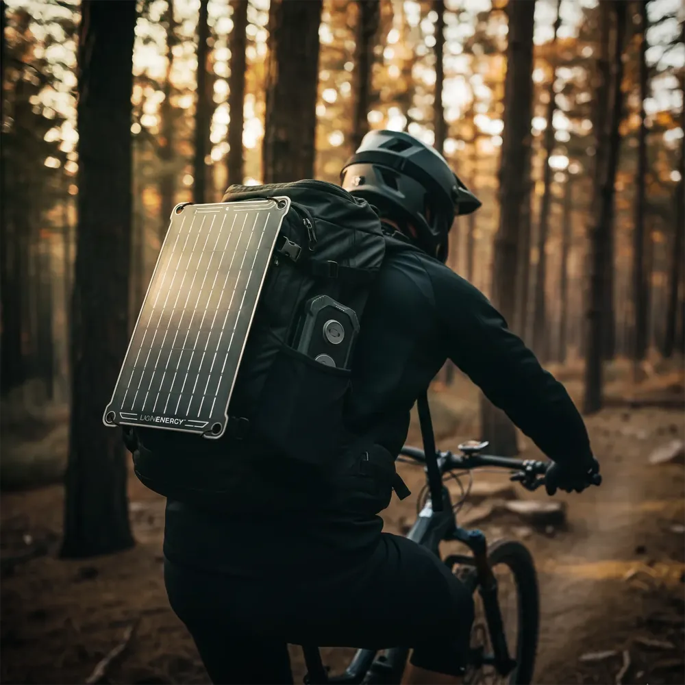 Cyclist carrying Lion Energy solar panel and Eclipse Mag power bank