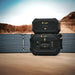 Lion Energy Safari XP 2688Wh expansion battery stacked above Safari power station with folding solar panels in a desert landscape