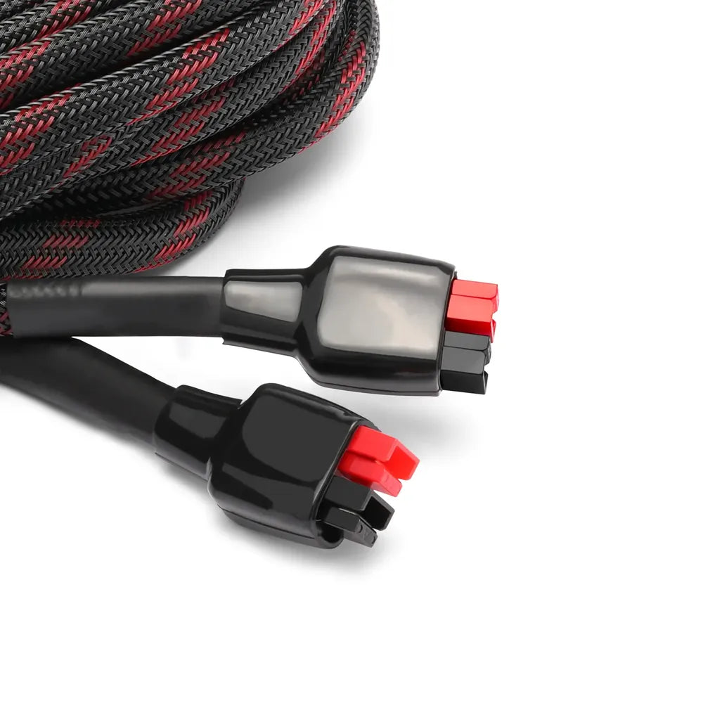 Close-up of Lion Energy 25-foot solar extension cable connectors with red and black ends and braided black-and-red protective sleeving