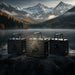 Three Lion Energy UT 1300 BT-H batteries arranged on lakeside rocks with snowcapped mountains and calm water behind them, emphasizing portable off-grid power storage
