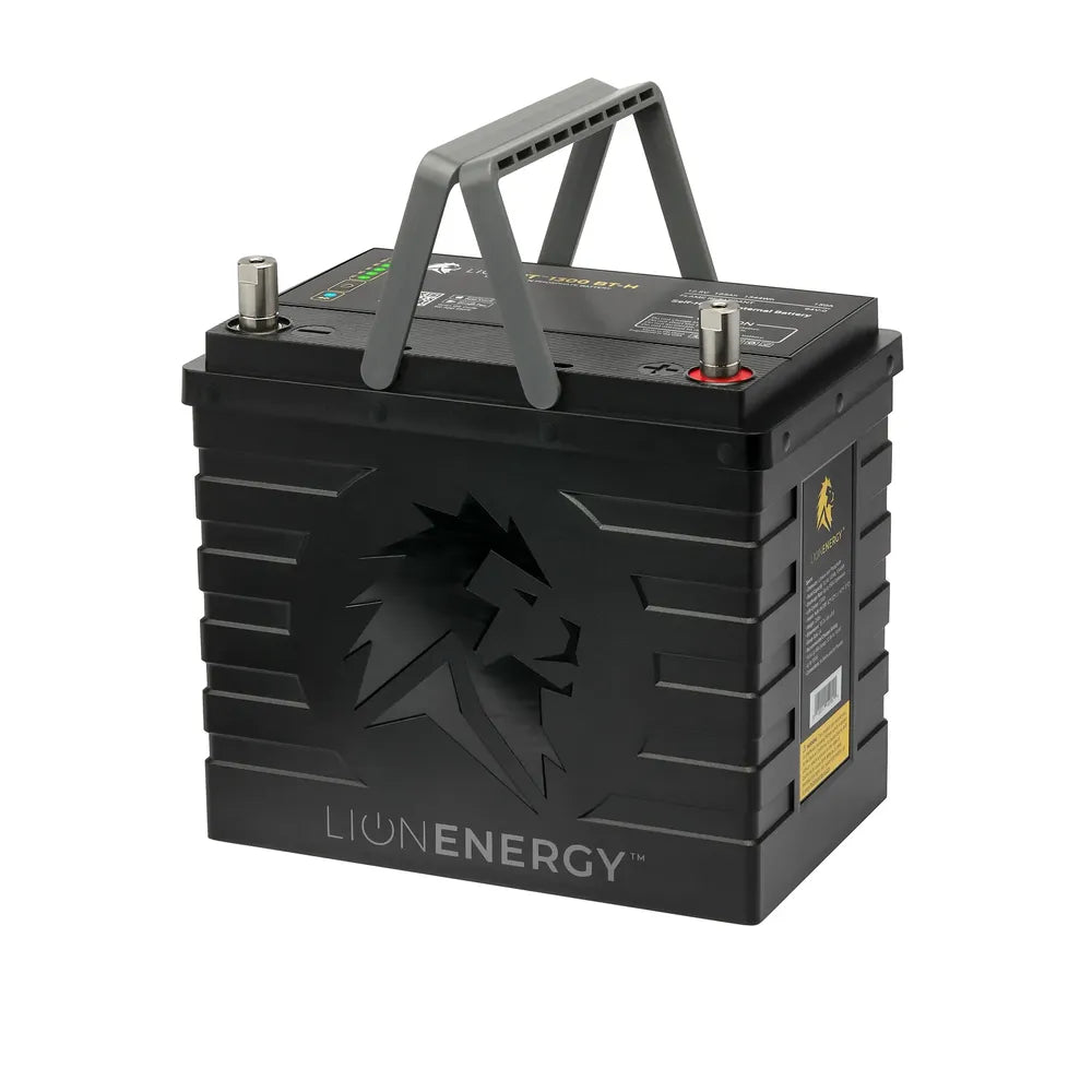 Angled product view of a single Lion Energy UT 1300 BT-H battery with fold-up carry handle, black housing, top-mounted terminals, and lion logo on the front