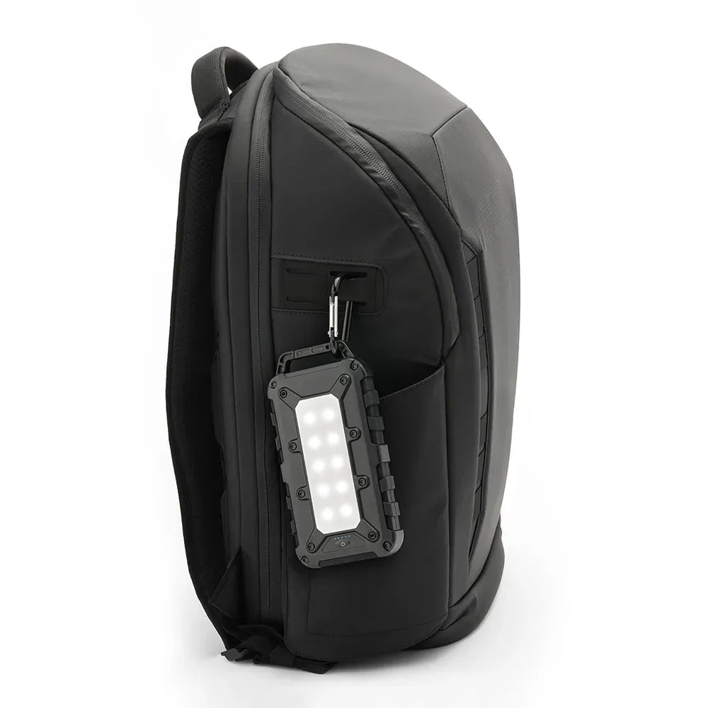 Lion Energy Lion Cub camping power bank clipped to backpack