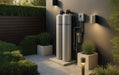Modern outdoor installation of the AlkaViva UltraHome water filtration and softener system featuring durable, weather-resistant grey tanks and integrated plumbing.