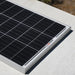 Close-up view of a Rich Solar MEGA 100 monocrystalline solar panel cell grid under bright direct sunlight.