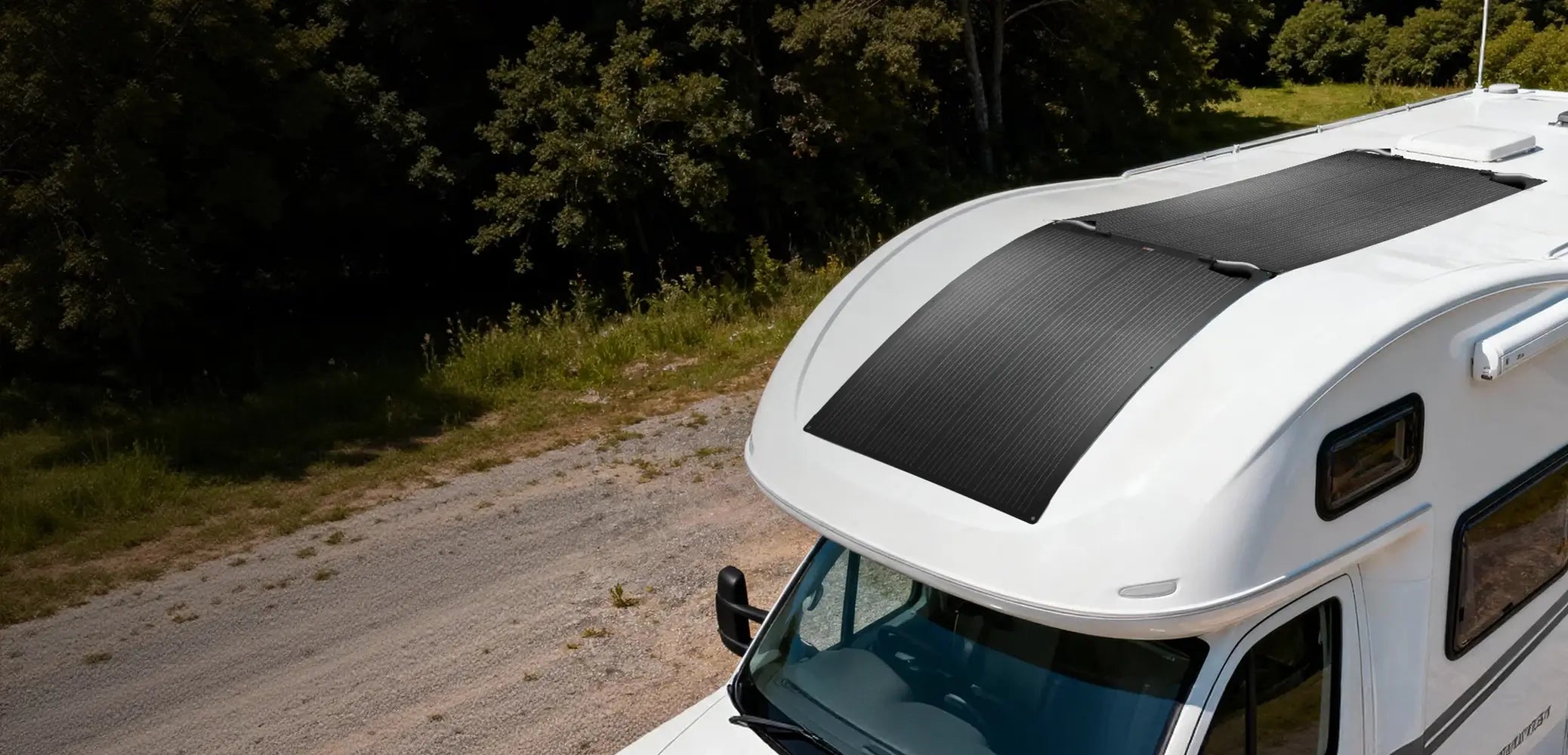 Aerial drone view of two Rich Solar MEGA 200 PRO FLEX 200W solar panels seamlessly installed on the curved roof of a white camper van.