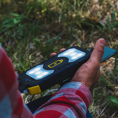 Lion Energy Prowler charging smartphone outdoors with LED light