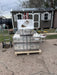 Freight shipment of Rich Solar 48V 100Ah LiFePO4 lithium-ion batteries with visible class 9 hazard labels delivered in front of a solar shed.