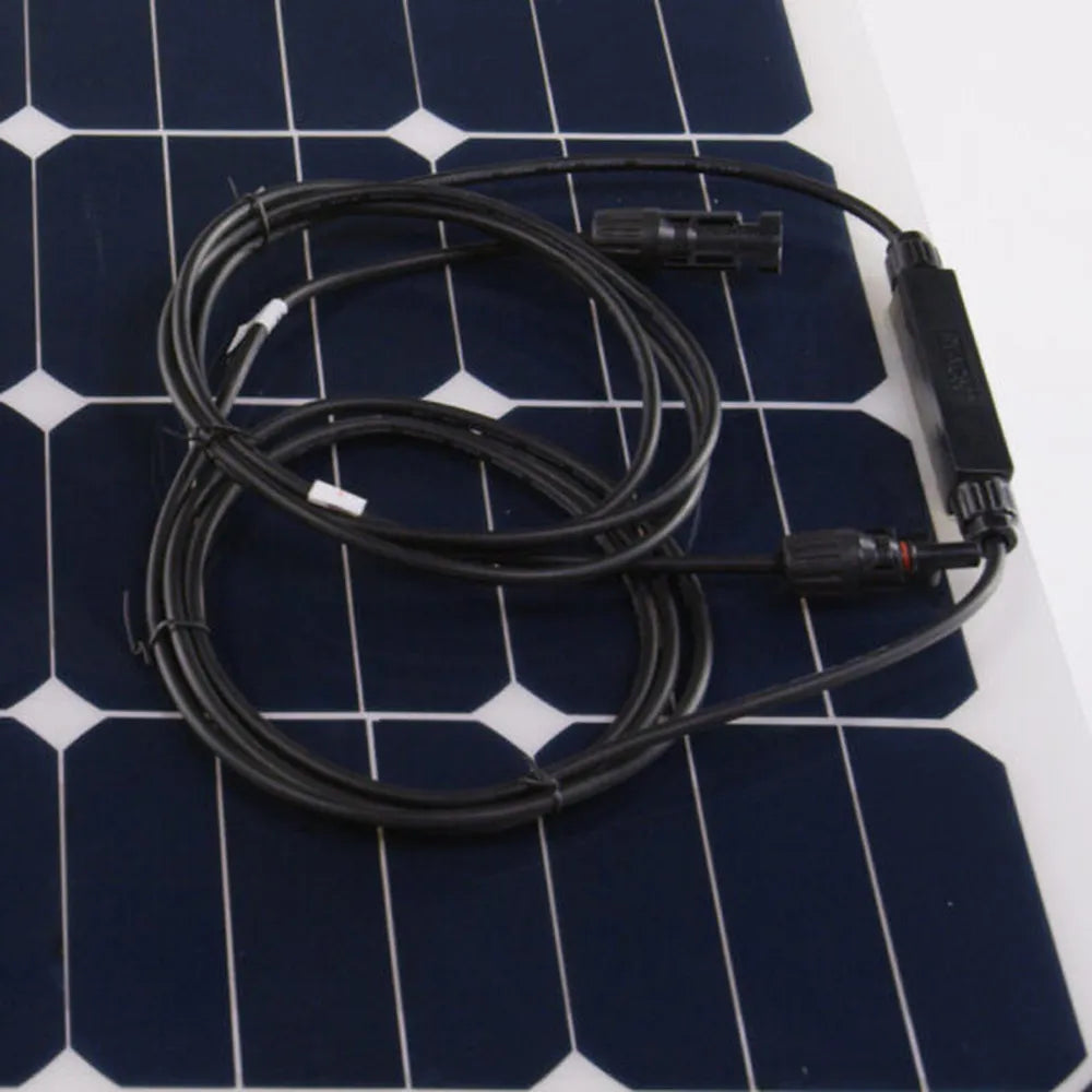 Close-up of AIMS Power flexible solar panel cable leads and MC4-style connectors coiled on the photovoltaic cell surface.