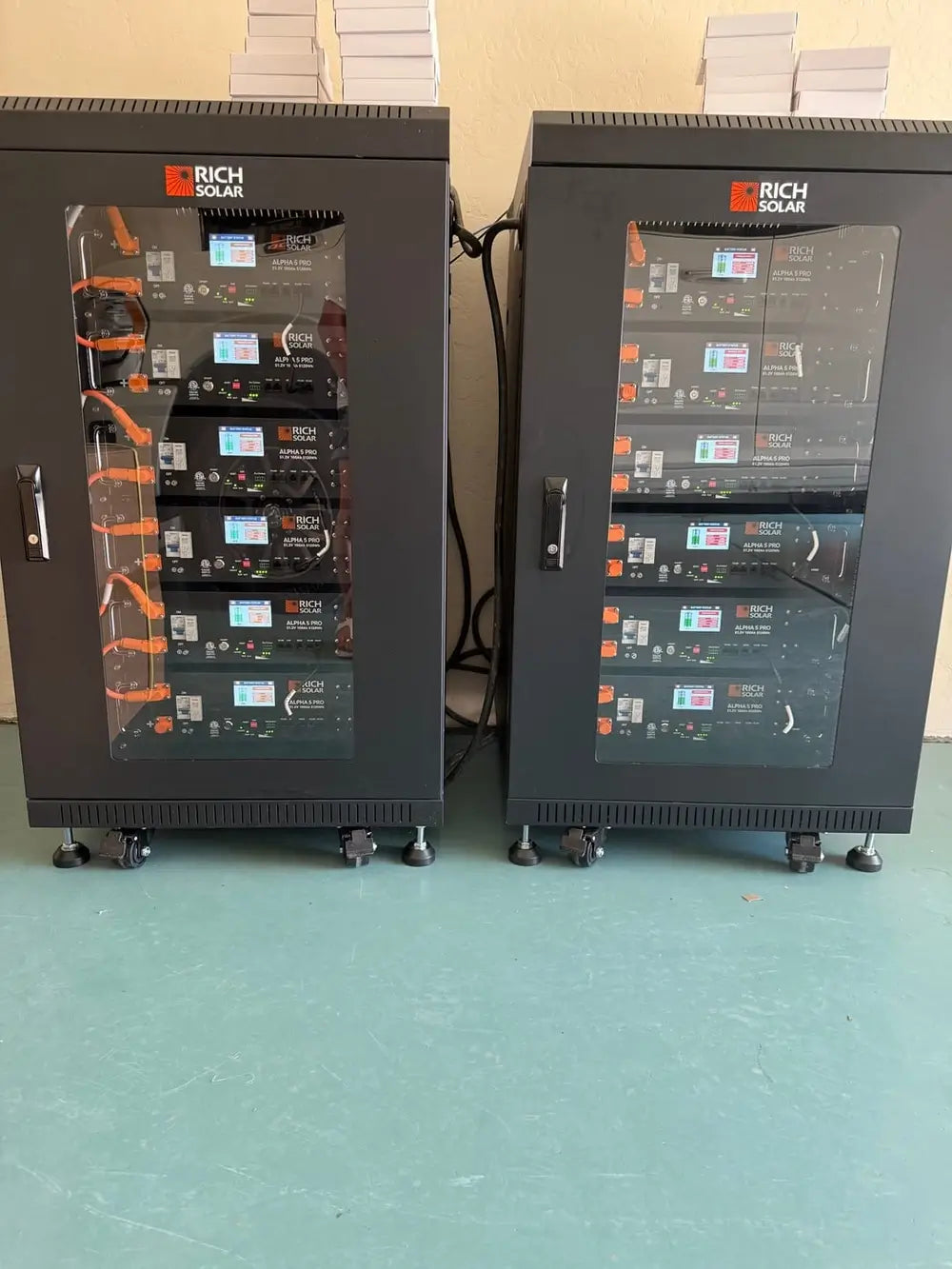 Two fully populated Rich Solar lithium battery server racks installed side-by-side for a 61.44kWh home energy storage system.