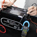 AIMS Power 600V True RMS clamp meter testing lithium iron phosphate battery voltage and terminals.