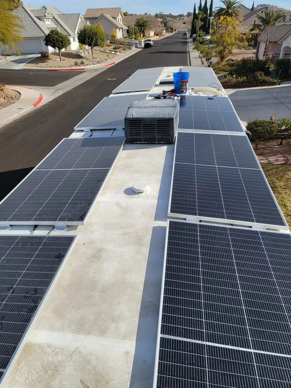 Multiple Rich Solar MEGA 335 PRO solar panels installed on an RV roof surrounding an air conditioner unit.