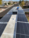 Multiple Rich Solar MEGA 335 PRO solar panels installed on an RV roof surrounding an air conditioner unit.