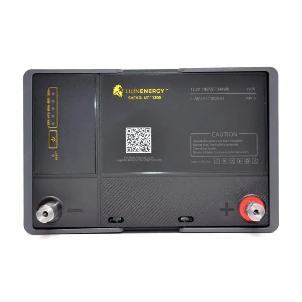 Top view of Lion Energy Safari UT 1300 battery showing positive and negative terminals, charge indicator panel, QR code, and printed battery specifications on a light gray background
