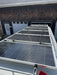 Off-grid RV solar panel installation featuring multiple Rich Solar panels mounted flat on the roof of a camper van conversion.