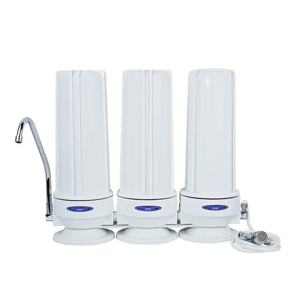 Crystal Quest triple stage white polypropylene fluoride countertop water filter system for advanced multi-stage filtration.